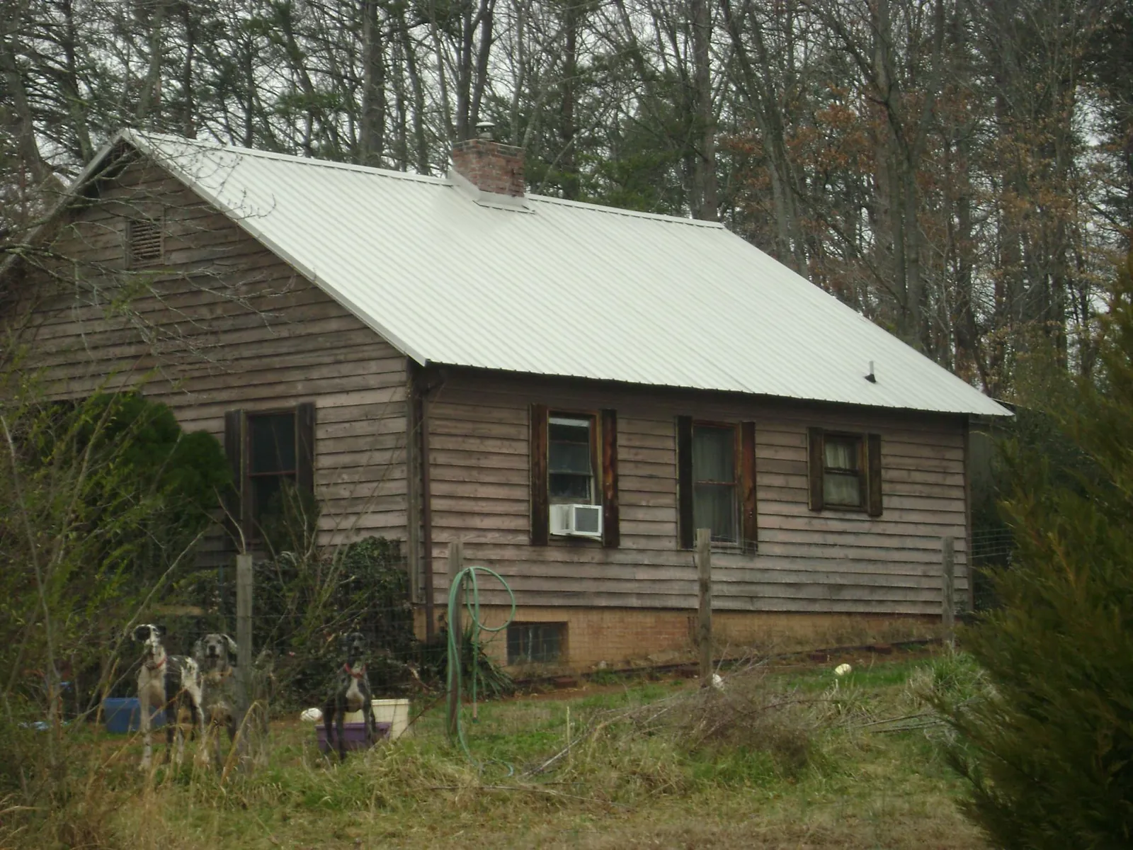 White metal roof on an old wood sided farmhouse, from a Metal Roof Installation job in Dry Run